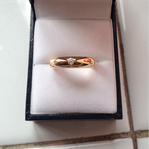 Gold ring with a small diamond in jewellery box