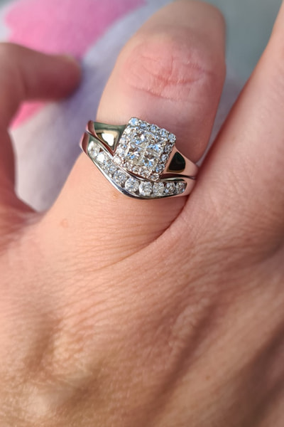 Diamond and gold ring on index finger